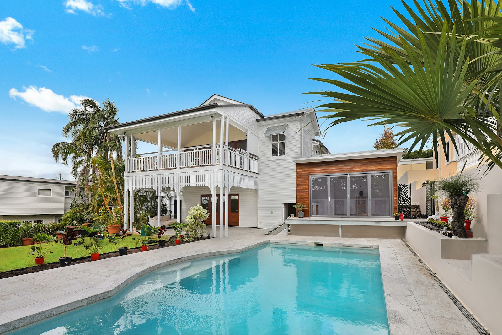 Warm white residential exterior with garden — the emotional weight of keeping the home.