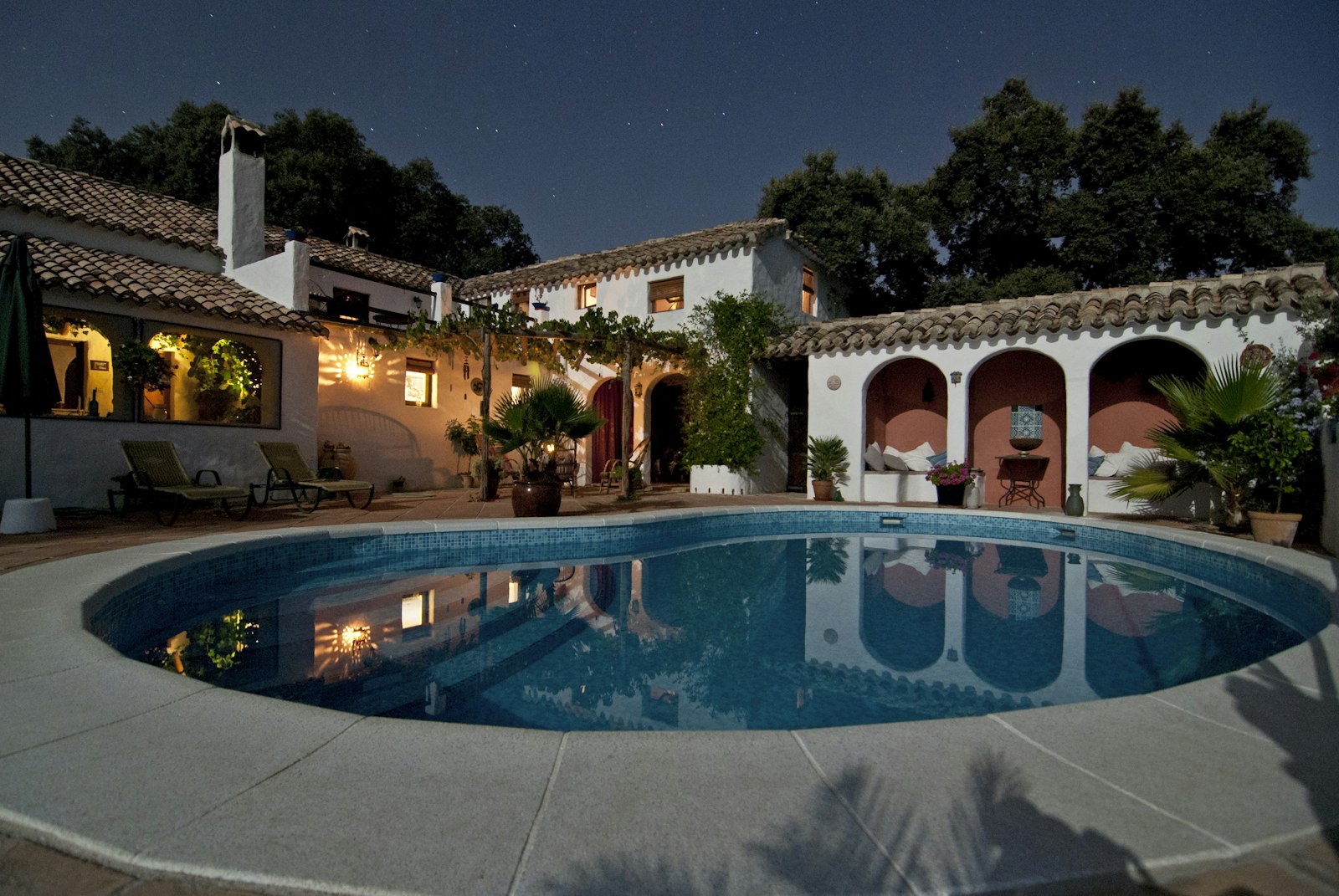 Warm residential exterior at night — the weight of a refinance decision after divorce.